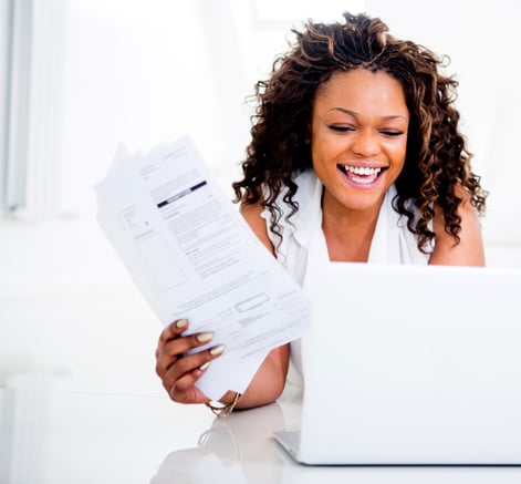 Woman paying her bills at home on her laptop